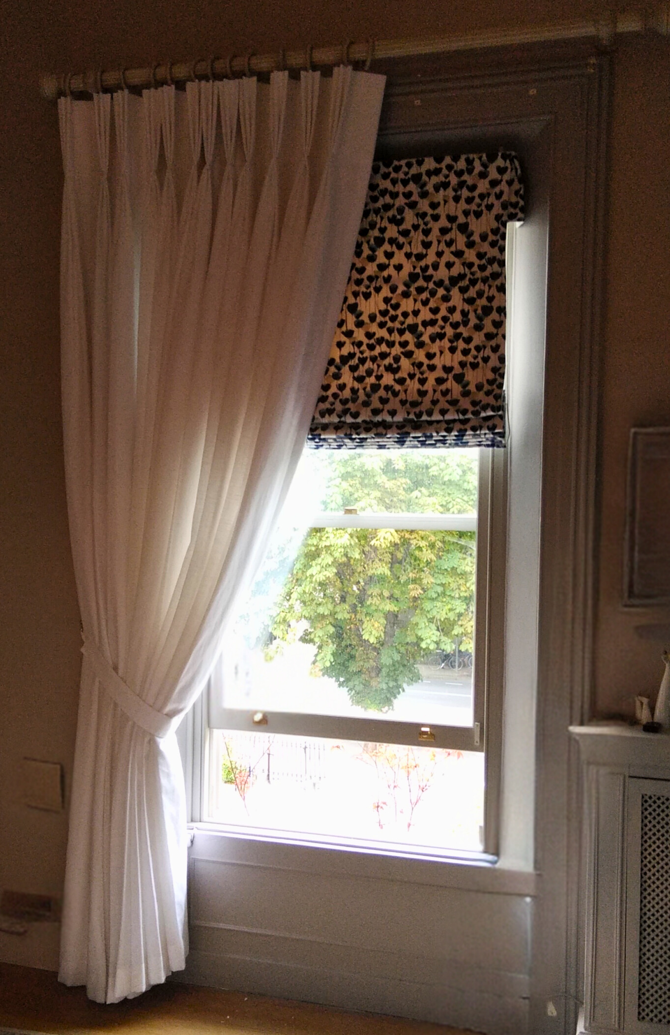 Voile curtains with roman blinds behind